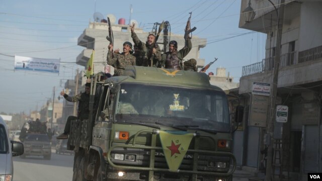 FILE - Members of the Kurdish People's Protection Units (YPG) return to Qamishli after a battle near Hasaka, March 14, 2015. (Z. Omar/VOA)