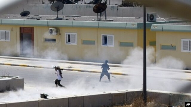 Libyan rebels continue to fight inside Moammar Gadhafi's compound Bab al-Aziziya in Tripoli, Libya, early Wednesday, August 24, 2011