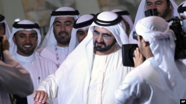 Sheikh Mohammed bin Rashid Al Maktoum (C), vice president of the UAE and ruler of Dubai, casts his vote at a polling station during the Federal National Council elections in Dubai, September 24, 2011.