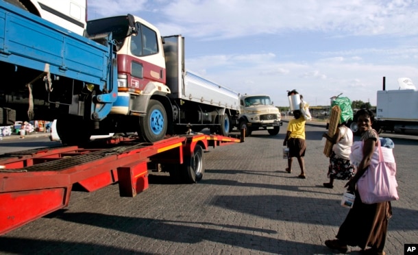 FILE - Trucks laden with goods headed for Zimbabwe are seen near the Beitbride border post between South Africa and Zimbabwe, in Musina, South Africa, March 28, 2008.
