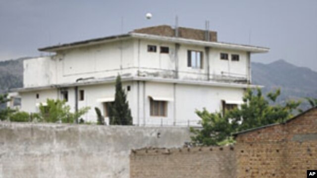 Resident Adeel, 8, plays with a tennis ball in front of the compound where U.S. Navy SEAL commandos reportedly killed al-Qaida leader Osama bin Laden in Abbottabad, May 5, 2011