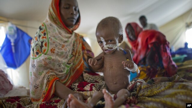 Zara Mahamat, suffering from malnutrition, receives treatment in an intensive care tent at the hospital in N'Gouri, a desert village in Chad, April 18, 2012.