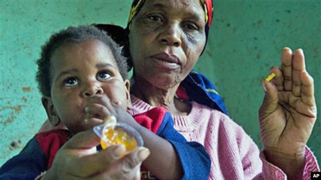 HIV positive child  is given some jam prior to her ARV medication by a care giver near Durban South Africa, November 2010 (file photo)