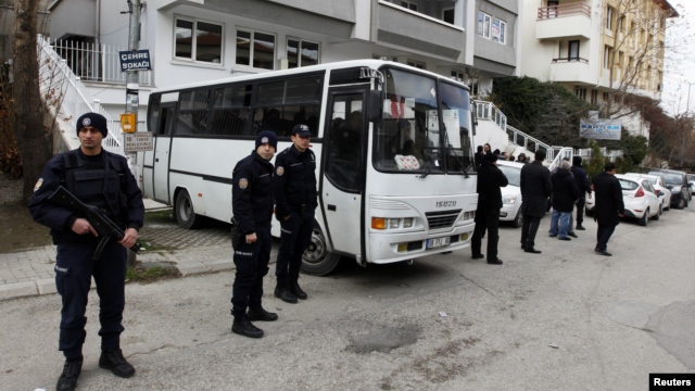 Riot police stand guard in front of a labor union office in Ankara, February 19, 2013. Police launched raids across Turkey early Tuesday targeting a militant leftist group behind a suicide bomb attack on the U.S. embassy.