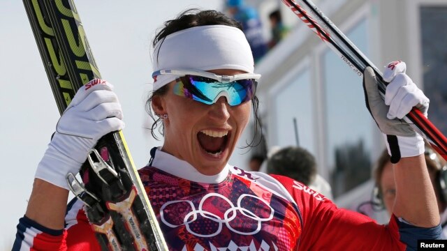 Norway's Marit Bjoergen celebrates after competing in the women's cross-country 30 km mass start free event at the Sochi 2014 Winter Olympic Games in Rosa Khutor, Russia, Feb. 22, 2014. 