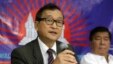Exiled Cambodian opposition leader Sam Rainsy, left, talks about the opposition's plans for 2013 elections in Cambodia on Sept. 10, 2012, in San Juan, Philippines. 