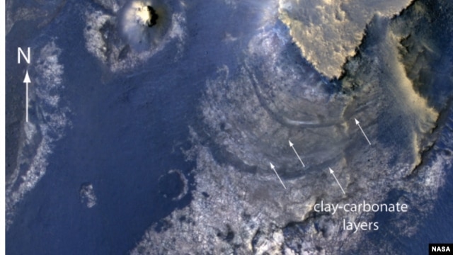 This view of layered rocks on the floor of McLaughlin Crater shows sedimentary rocks on Mars that contain spectroscopic evidence for minerals formed through interaction with water. 