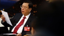 Zhang Dejiang reads his statement during a meeting held on the sidelines of the 18th National Congress of the Communist Party of China (CPC), at the Great Hall of the People in Beijing, November 8, 2012. 