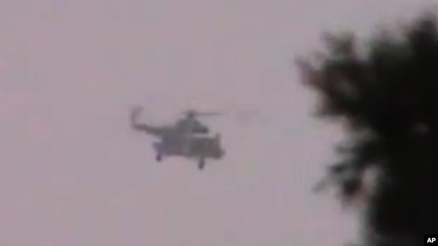 Shaam News Network image purports to show Syrian helicopter firing on village near Daraa, June 16, 2012.