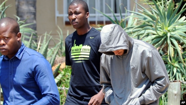 Olympic athlete Oscar Pistorius leaves the Boschkop police station, east of Pretoria, South Africa, Feb. 14, 2013 en route to appear in court charged with murder. 