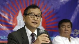 Cambodian opposition leader Sam Rainsy, left, who is currently living in exile in France, talks about the opposition's plans for next year's elections in Cambodia during the launching of the International Parliamentary Committee for Democratic Elections in Cambodia with Philippine Sen. Franklin Drilon Monday, Sept. 10, 2012, in San Juan, east of Manila, Philippines. Rainsy, who is planning to go back to Cambodia before the July 2013 elections in Cambodia, is leading the opposition and enlisting several parliamentarians from neighboring southeast Asian nations as well as other Asian countries to push for  "clean and democratic" elections in Cambodia.