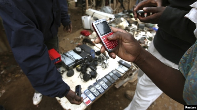 A vendor hawks second-hand mobile phones at the sprawling Kibera slum, one of the largest and poorest slums in Africa, near Kenya's capital Nairobi, August 26, 2011. 