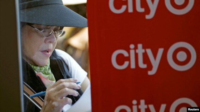 A woman fills out an application for one of the 300 available positions at a new Target retail store in San Francisco, California, August 9, 2012. 