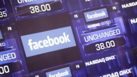 A screen at NASDAQ in New York City lists Facebook on its first day of public trading. 