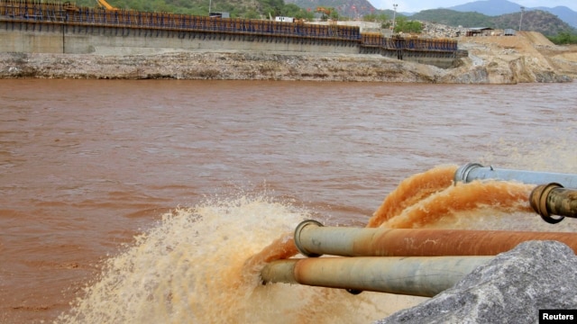 FILE - Water gushes out from pipes by the construction of Ethiopia's Great Renaissance Dam in Guba Woreda, some 40 kilometers from Ethiopia's border with Sudan.