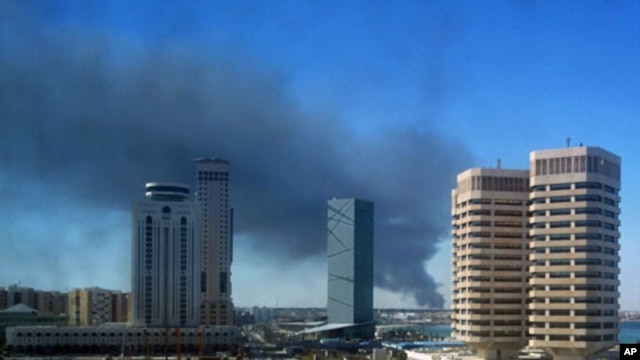 Smoke rises over the western side of Tripoli, October 14, 2011