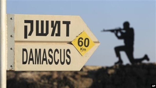 Sign showing distances to Damascus and a cut out of a soldier are seen at an army post from the 1967 war at Mt. Bental, Golan Heights, July 24, 2012.