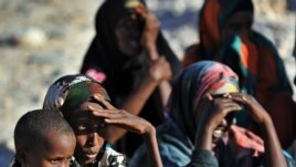 Somali women and children wait for relief supplies from the UN High Commission for Refugees, in Galkacyo, Somaliland, December 2010. (file photo)
