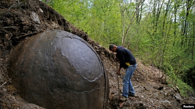 Suad Keserovic cleans a stone ball in Podubravlje village near Zavidovici, Bosnia and Herzegovina, April 11, 2016.