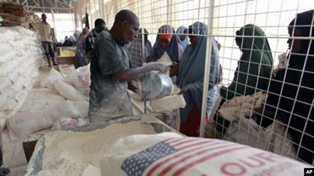 Newly arrived Somali refugee women receive relief food at a the World Food Program distribution center at the Ifo refugee camp in Dadaab, near the Kenya-Somalia border, August 1, 2011