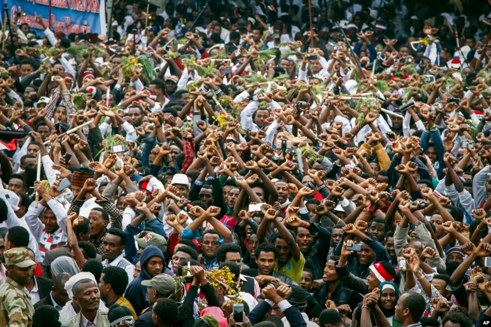 FILE - In this Sunday, Oct. 2, 2016 file photo, protesters chant slogans against the government during a march in Bishoftu, in the Oromia region of Ethiopia.