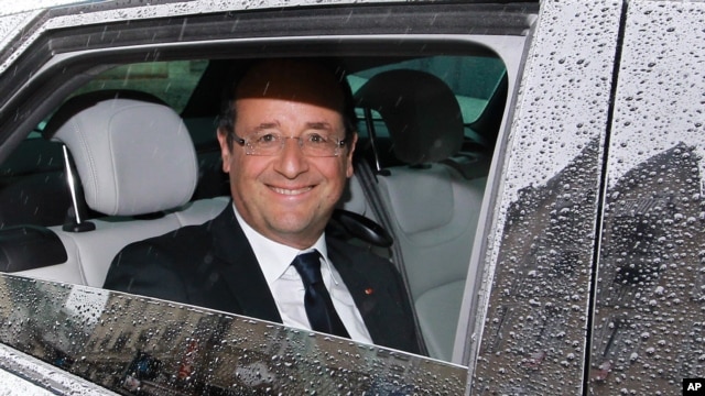 French President Francois Hollande reacts after leaving a restaurant in Tulle, central France, June 10, 2012.