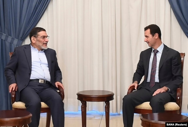 FILE - Syria's President Bashar al-Assad, right, meets Admiral Ali Shamkhani, Iran's Supreme National Security Council Director, in Damascus, Sept. 30, 2014.