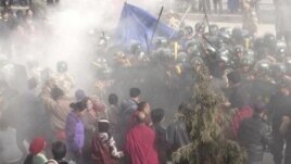 In this handout photo released by The International Campaign for Tibet (ICT) on December 7, 2012, paramilitary policemen are seen closing in on Dorje Rinchen's body after his self-immolation, in Xiahe, Gannan Tibetan Autonomous Prefecture, Gansu province, October 23, 2012.
