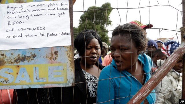 FILE - Women fleeing attacks on immigrants line up for food at a temporary refugee camp in east of Johannesburg, South Africa, Apr. 20, 2015.