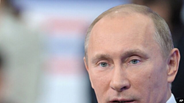 Russian Prime Minister Vladimir Putin gestures while a national call-in TV show in Moscow, Russia. Putin said Thursday the results of Russia's parliamentary election reflected the people's will, and that the opposition had alleged vote fraud purely to str