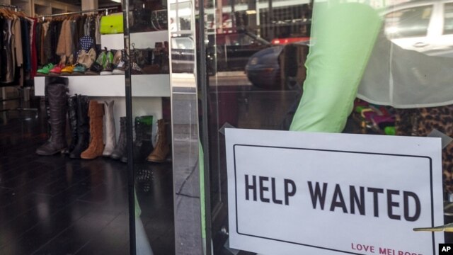 A help wanted sign is posted on the front window of a clothing boutique in Los Angeles, December 7, 2012.