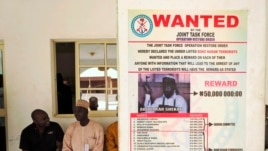 FILE - A poster announcing a reward for the capture of Boko Haram leader Abubakar Shekau is seen on a wall in Baga village on the outskirts of Maiduguri in the north-eastern Nigerian state of Borno.