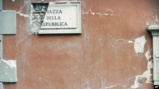 Rubble lies on the ground beside a postbox in the Piazza della Repubblica in Central L'aquila (January 2010 file photo)