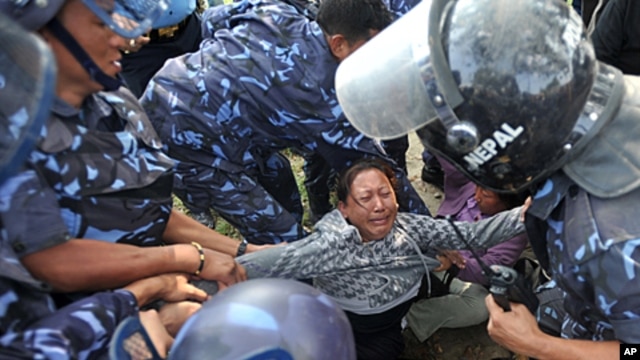 Nepalese riot police arrest Tibetan protesters near the Jwalakhel Refugee Camp in Kathmandu, November 1, 2011.