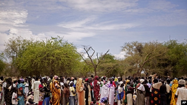 Women line up for food distribution in a makeshift camp for internally displaced people in the village of Mayen Abun, southern Sudan,  May 26, 2011