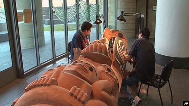 David Boxley works at the National Museum of the American Indian in Washington on one of the totem poles that he created with his son