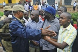 Uganda's main opposition leader Kizza Besigye (2nd R, blue cap) and his supporters are blocked by policemen during a Walk to Work protest in the Kasangati suburb near Uganda's capital Kampala, Uganda, October 18, 2011.
