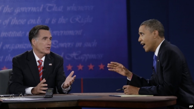 President Barack Obama, right, and Republican presidential nominee Mitt Romney discuss a point during the third presidential debate at Lynn University in Boca Raton, Florida, October 22, 2012.