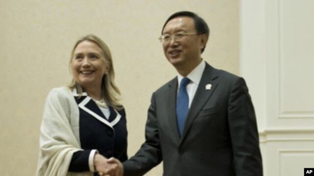 U.S. Secretary of State Hillary Rodham Clinton, left, and Chinese Foreign Minister Yang Jiechi pose for photos before their meeting on the sideline of the ASEAN regional forum in Phnom Penh, July 12, 2012.
