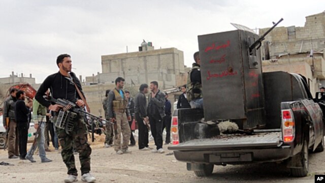 Members of the Free Syrian Army are seen deployed in al-Bayada, Homs, February 29, 2012.