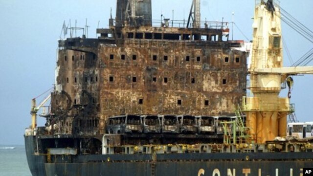 The MV Pacific Express which was set on fire by suspected Somali pirates on September 21, 2011 is towed along the Likoni channel by Kenya Ports Authority tug boats to the port of Mombasa, Kenya. (File Photo - September 30, 2011)