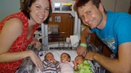 A photo provided by Texas Children's Hospital shows Lauren and David Perkins with three of their six children born prematurely in April