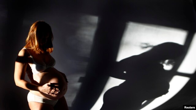 Pregnant Sabine Heinrich (36) is pictured while posing in her living room in Eichenau, December 12, 2012.