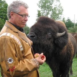 John Trippy, owner of the Wild Winds Buffalo Preserve, with one of his animals.