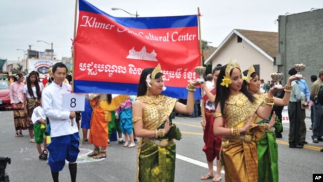Cambodian traditional dancers give blessing during an annual parade in the designated 'Cambodia Town' section of Long Beach, California, on April 2, 2011, to celebrate Khmer New Year.