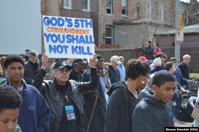 Participants march for peace in a prayer walk, April 14, 2017, through one Chicago neighborhood hit hard by gun violence, the Englewood neighborhood on Chicago's South Side.