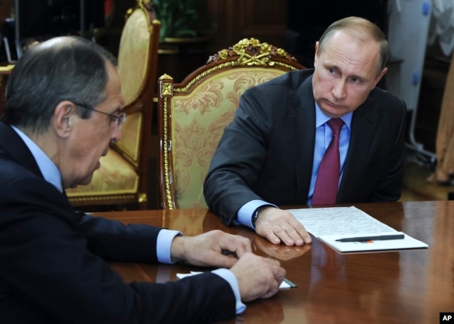 FILE - Russian President Vladimir Putin, right, listens to Russian Foreign Minister Sergey Lavrov during their meeting in the Kremlin in Moscow, Russia, March 14, 2016.