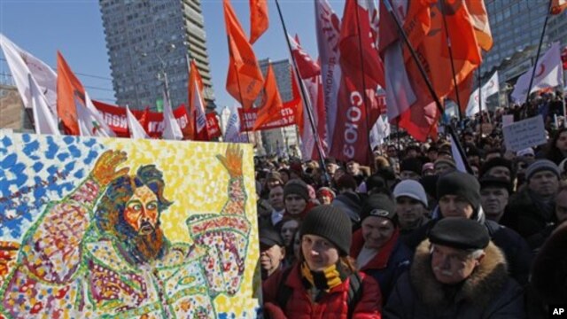 Opposition protesters with a placard depicting Czar Ivan The Terrible gathered during a rally in Moscow, Russia,  March 10, 2012. 