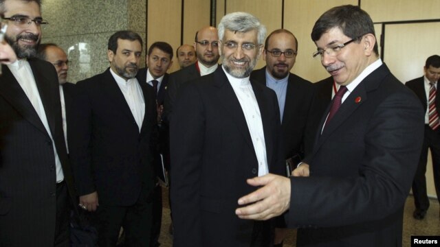 Turkey's Foreign Minister Ahmet Davutoglu [R] welcomes Iran's chief negotiator Saeed Jalili [2nd R] before their meeting in Istanbul, April 14, 2012.