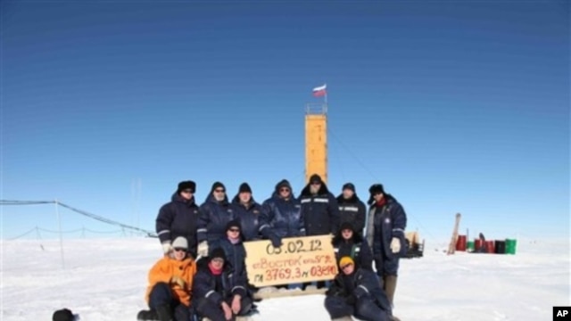 Russian researchers at the Vostok station in Antarctica after reaching subglacial Lake Vostok. Scientists hold a sign reading "05.02.12, Vostok station, boreshaft 5gr, lake at depth 3769.3 metres."
